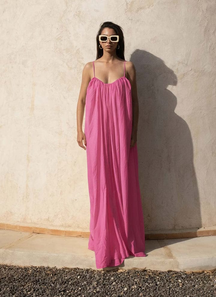 Pink Back Less Maxi Dress by Nextry.pk featuring a flowing silhouette and stylish open-back design.