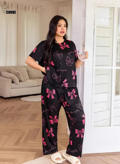 Black and pink night suit for girls and women made of premium fabric by Comfettie, shown laid out on a flat surface.