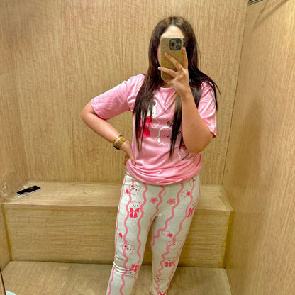 Pink happy bear design night suit by Comfettie, made of premium fabric for girls and women, featuring a cozy, playful look.