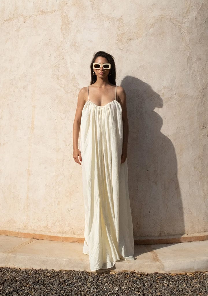 Nextry.pk backless maxi dress in flowing fabric, sleeveless design with a fitted waist and elegant floor-length style.