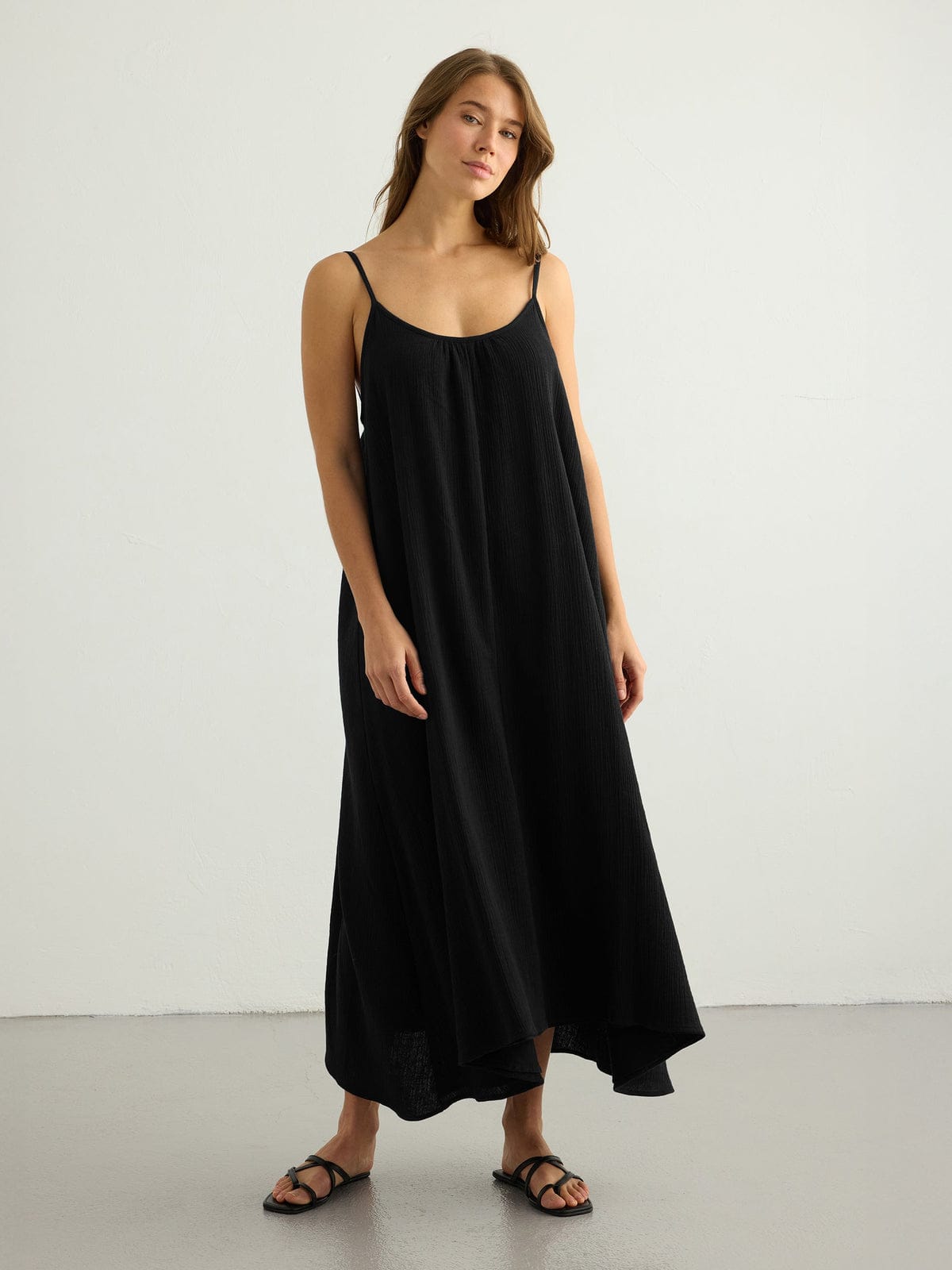 Black Back Less Maxi Dress by Nextry.pk featuring a stylish open back and flowing fabric for elegant summer wear.