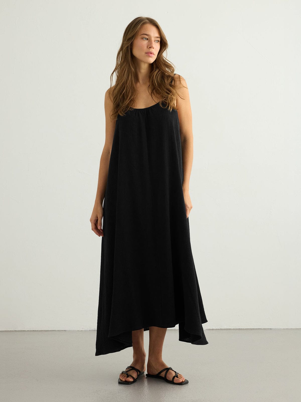 Black Back Less Maxi Dress by Nextry.pk, featuring a stylish open-back design and flowy silhouette, perfect for elegant occasions.