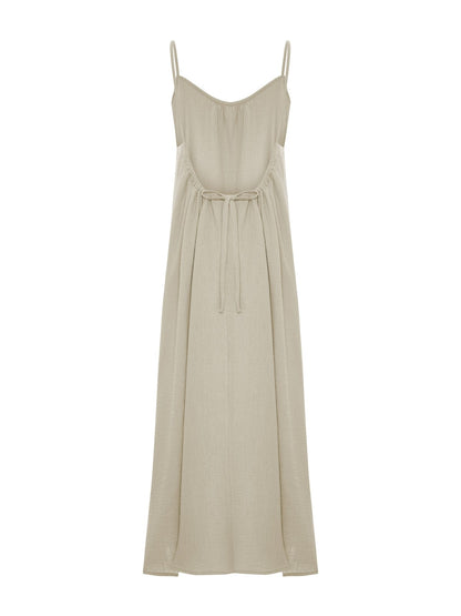Oatmeal Back Less Maxi Dress by Nextry.pk featuring a flowing silhouette and stylish open-back design.