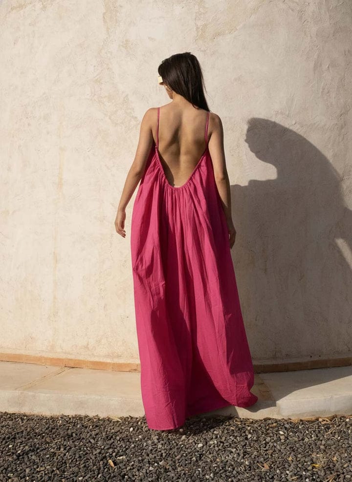 Pink Back Less Maxi Dress by Nextry.pk featuring a flowing silhouette and elegant design for stylish occasions.