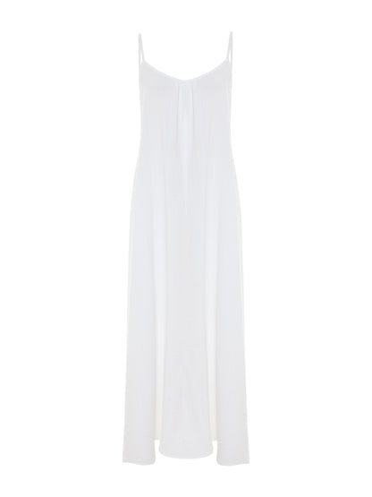 White Backless Maxi Dress by Nextry.pk featuring a flowing silhouette and elegant design.