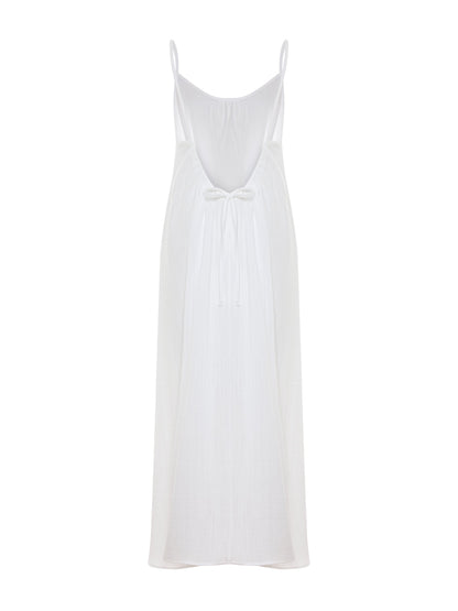 White Back Less Maxi Dress by Nextry.pk featuring a flowing design and open back for elegant summer wear.