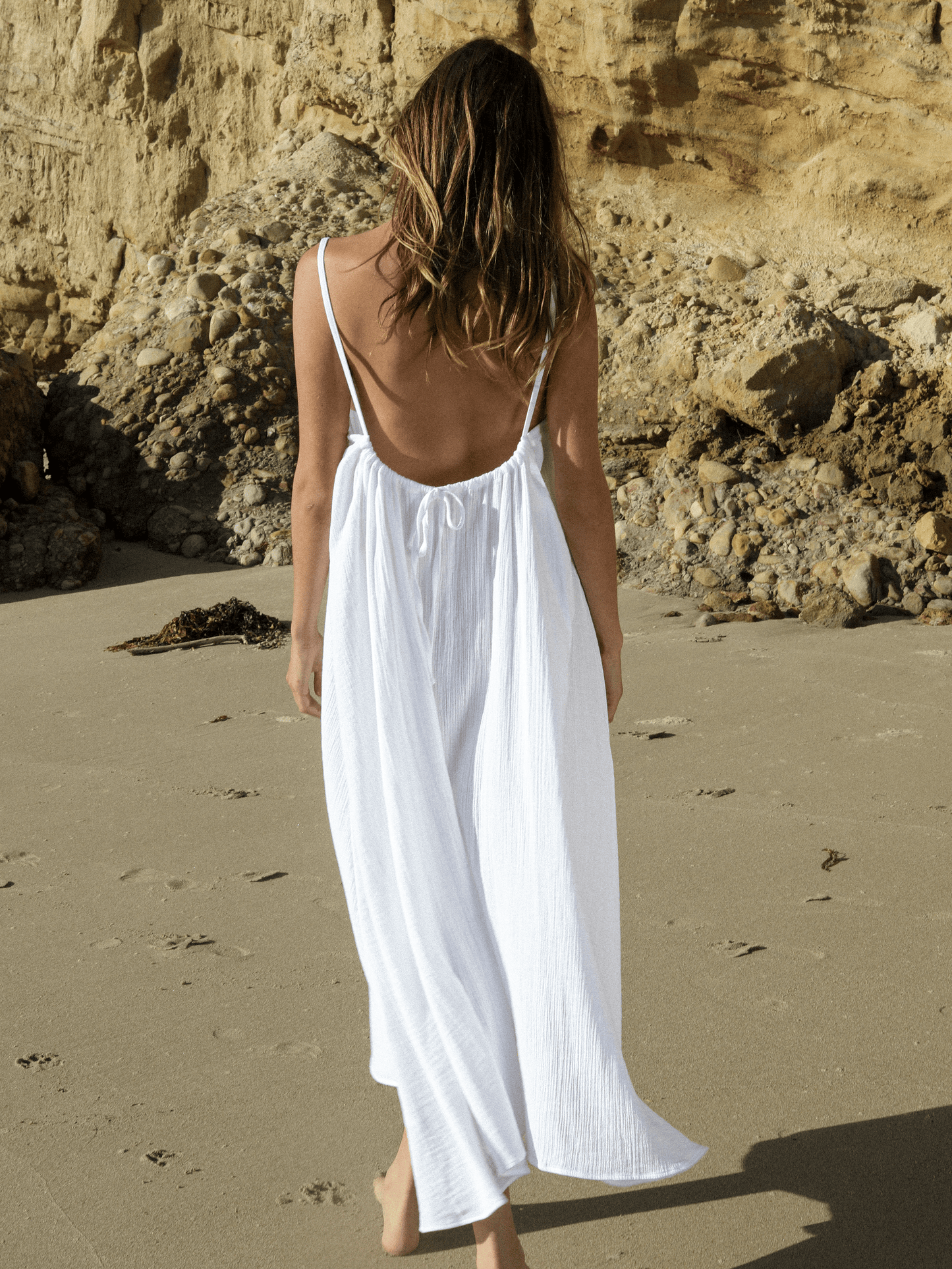 White Back Less Maxi Dress by Nextry.pk, featuring a flowy silhouette and open back design, perfect for elegant summer occasions.