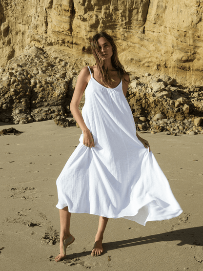 White Back Less Maxi Dress by Nextry.pk featuring a flowing fabric and open back design for a stylish summer look.