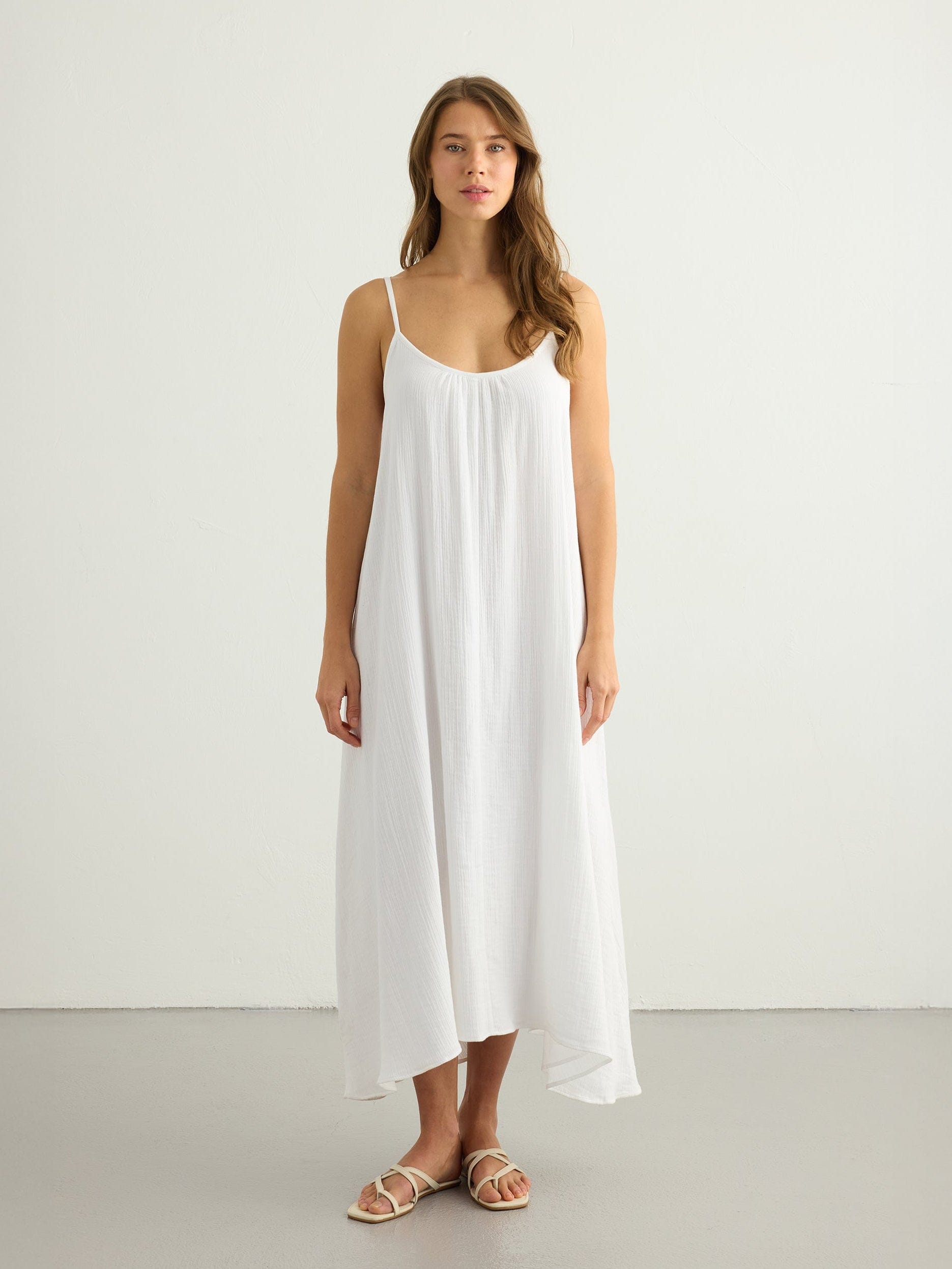White Back Less Maxi Dress by Nextry.pk, featuring a flowing silhouette and stylish backless design, perfect for elegant occasions.