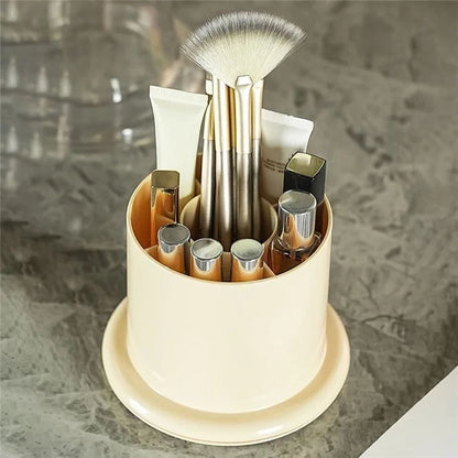 Rotating cosmetics and makeup brush organizer from Nextry.pk, showing a sleek, multi-compartment storage stand for beauty tools.