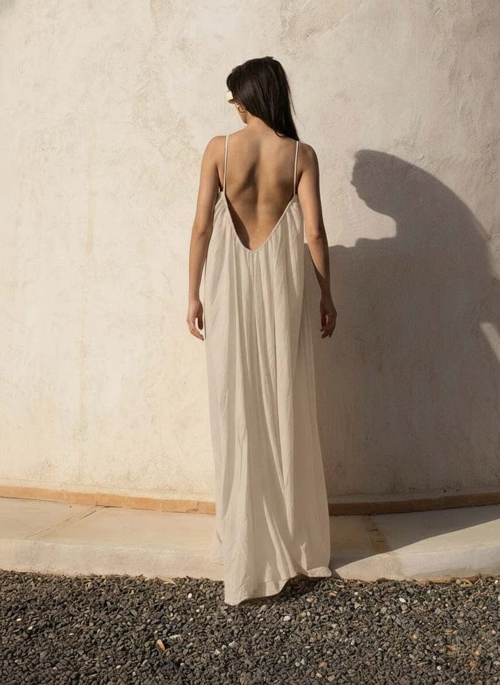 Nextry.pk backless maxi dress in flowing fabric, sleeveless design with a fitted bodice and elegant long skirt.