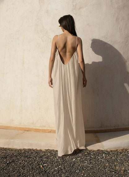 Nextry.pk backless maxi dress in flowing fabric, sleeveless design with a fitted bodice and elegant long skirt.