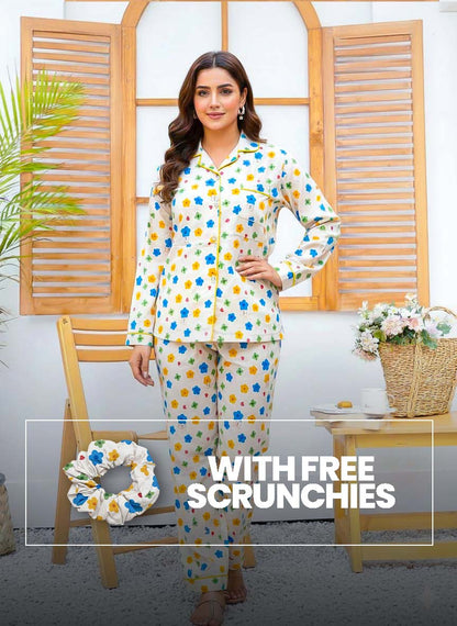 Light pink linen PJ set with colorful floral print and matching scrunchies from Night Need, comfortable sleepwear for women.