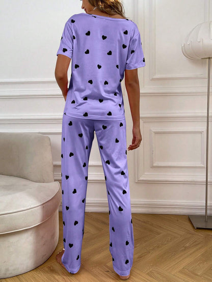Purple and black multi-heart printed women’s cotton jersey night suit with long sleeves and relaxed fit.