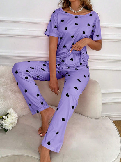 Purple and black multi-heart printed women's cotton jersey night suit with long sleeves and relaxed fit.