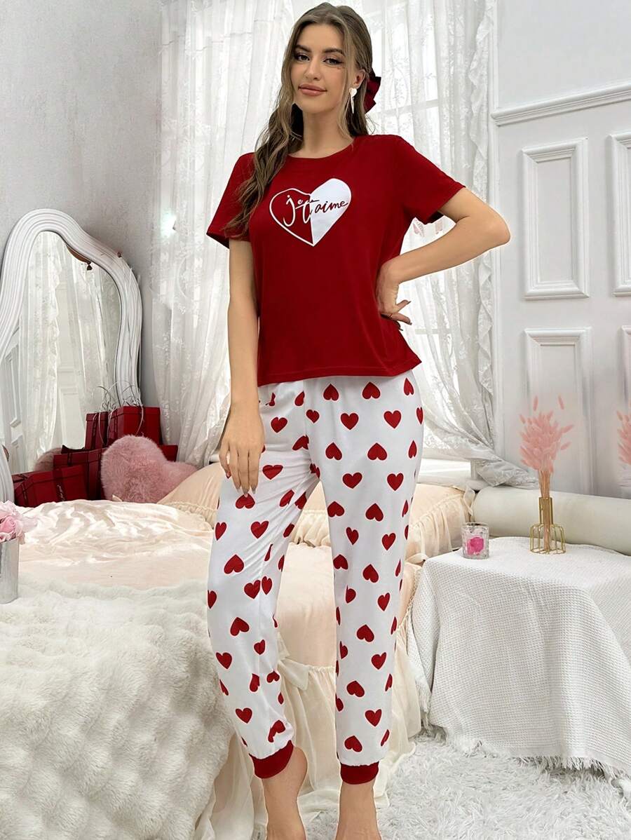 Red heart printed women's cotton jersey night suit, comfortable extended sleepwear by The Style Bazar, shown on a hanger.