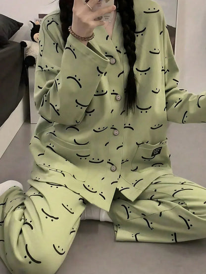 Green emoji printed V-neck cotton jersey night suit with button details, featuring a playful emoji pattern for comfortable sleepwear.