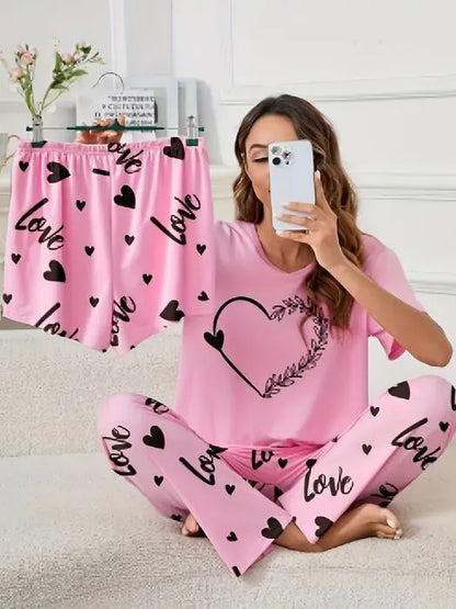 Pink heart-patterned women's 3-piece nightwear set by The Style Bazar, includes top, shorts, and matching pants for comfortable sleepwear.